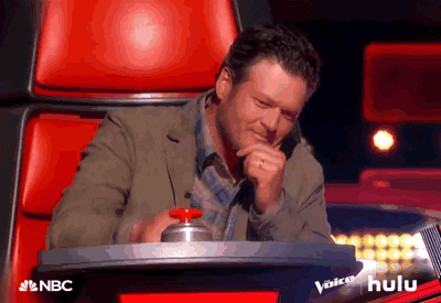 A gif of Blake Shelton hitting the button on "The Voice" so text lights up saying "I WANT YOU."