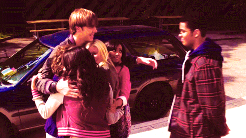 Teenagers all coming together for a group hug. 