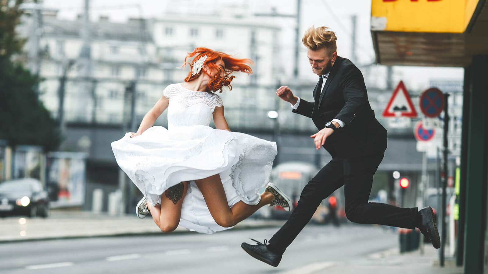 a couple dressed for a wedding dances in the street