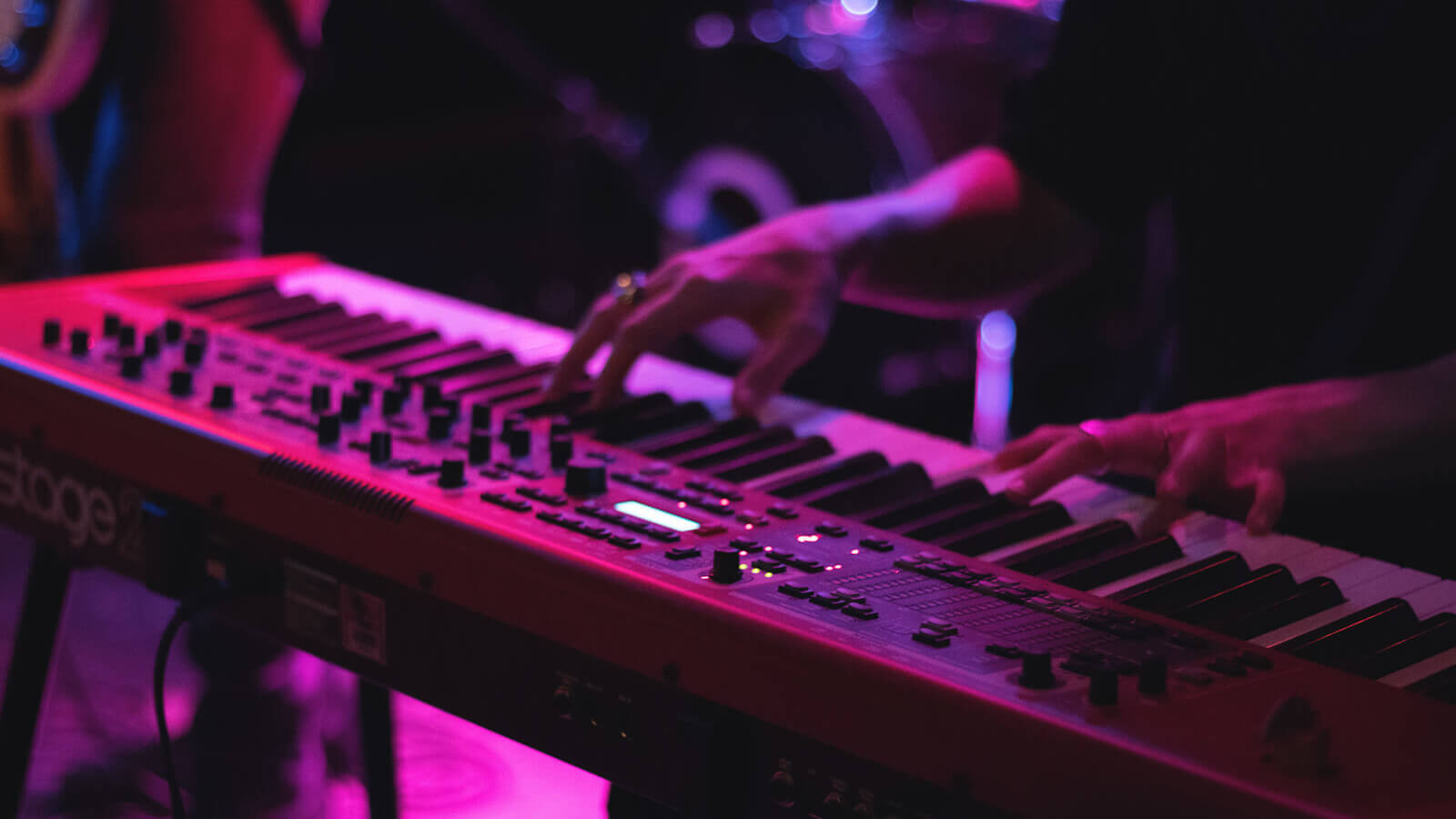 a man plays a keyboard on stage at a music show