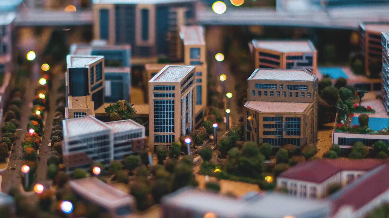 a mini model town with buildings, streets and lights