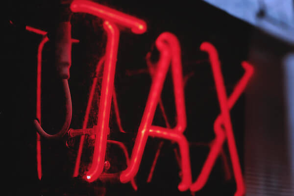 a red neon tax sign