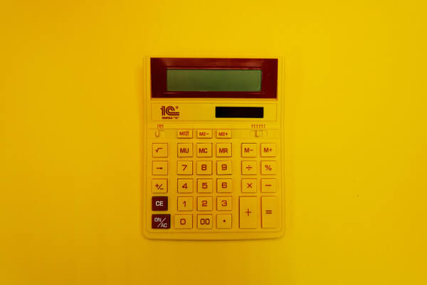 a calculator on a yellow backdrop