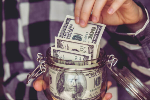 a mason jar with cash in it