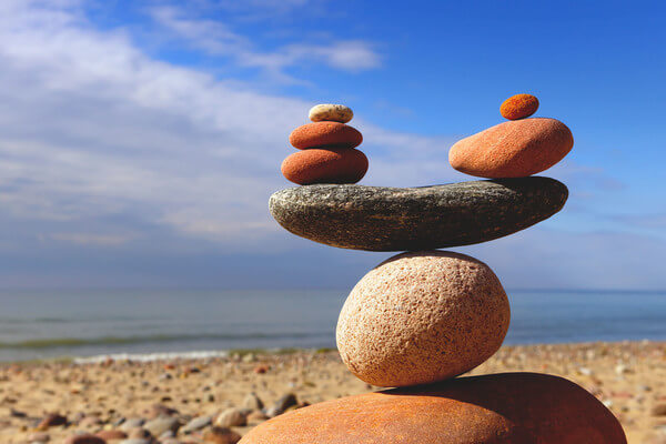 a stack of rocks balanced on the beach