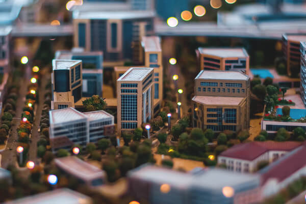 a mini model town with buildings, streets and lights